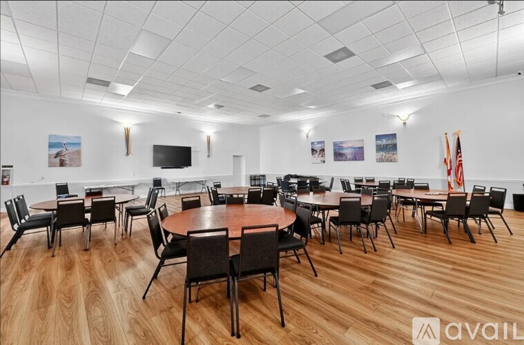 A conference room with a large table surrounded by chairs.