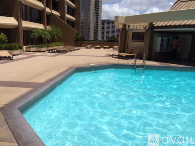 A swimming pool in a hotel courtyard.
