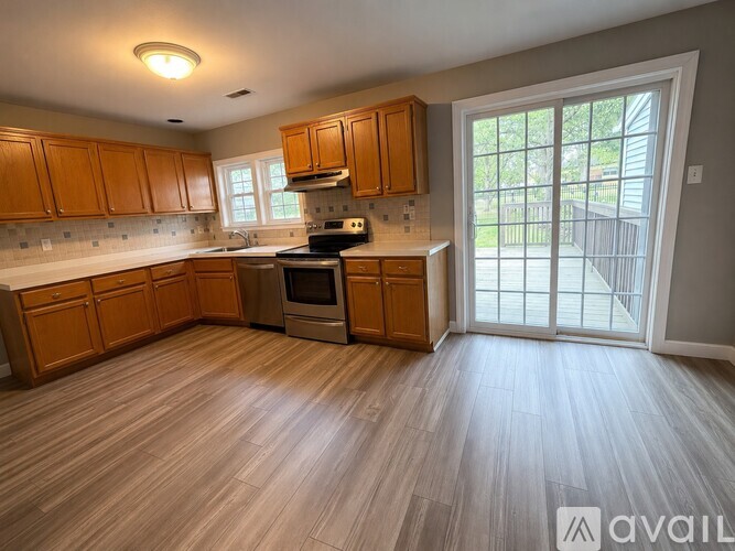 A kitchen with wooden cabinets and a stove top oven.