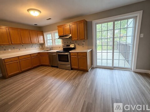 A kitchen with wooden cabinets and a stove top oven.