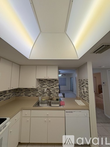 A kitchen with a sink and cabinets.