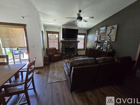 A living room with a brown couch and a wooden table.