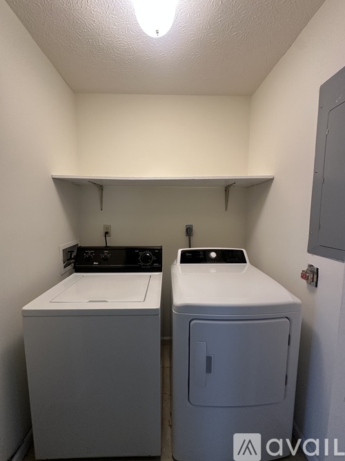 A small laundry room with a washer and dryer.