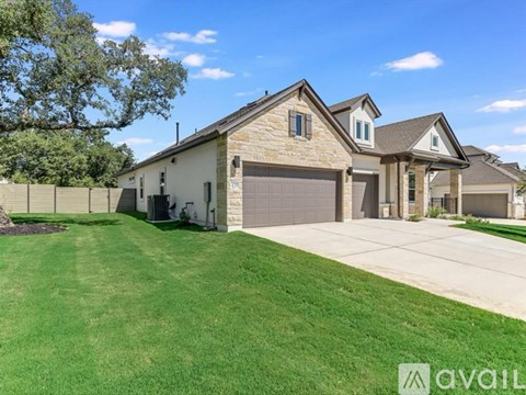 A house with a garage and a driveway is for sale.