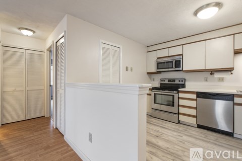 A kitchen with white cabinets and stainless steel appliances.