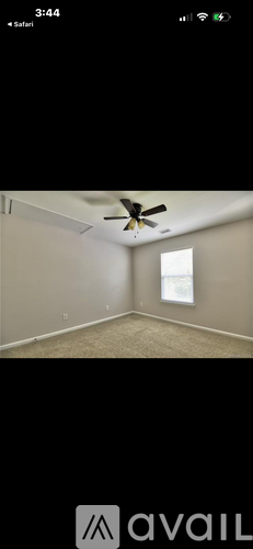 A room with a ceiling fan and a window.