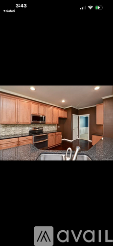 A kitchen with wooden cabinets and a granite countertop.