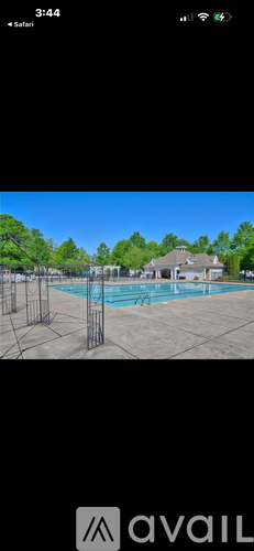 A pool surrounded by a metal fence.