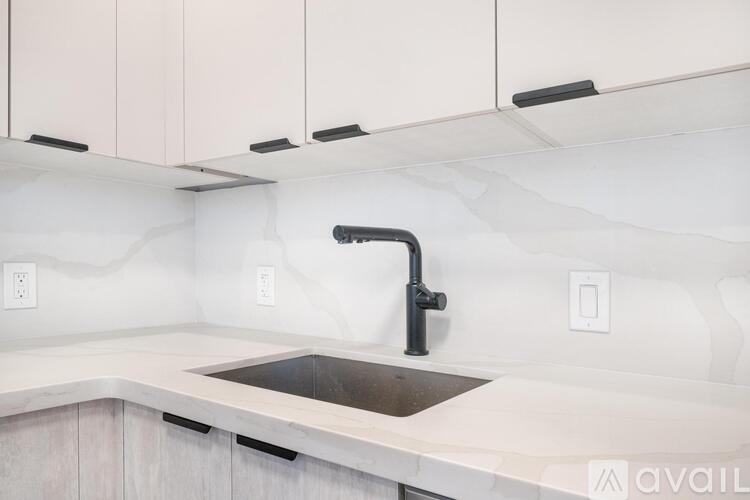A modern kitchen with a sink and cabinets.