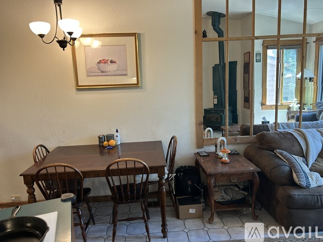 A dining room with a table and chairs.