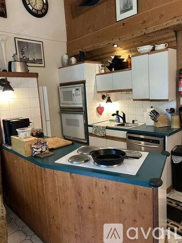 A kitchen with wooden cabinets and a green counter.