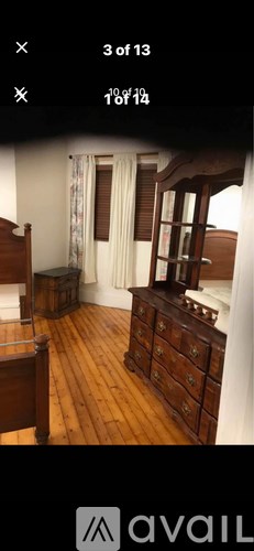 A bedroom with wooden floors and furniture.