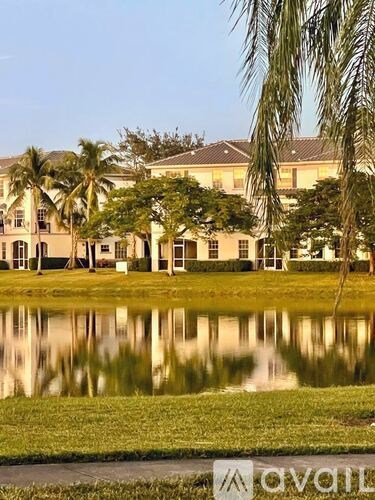 A large building with a reflective pool in front of it.
