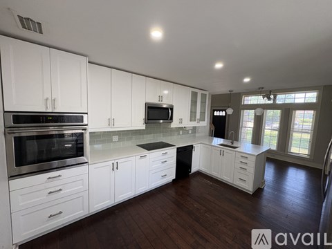 A kitchen with white cabinets and stainless steel appliances.