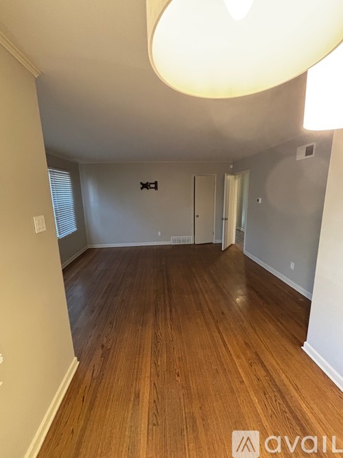 A room with wooden floors and a light fixture on the ceiling.