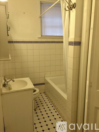 A white bathroom with a sink, toilet, and bathtub.