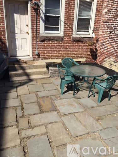 A patio with a table and chairs.