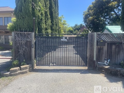 A gated entrance with a sign that says "NO PARKING".