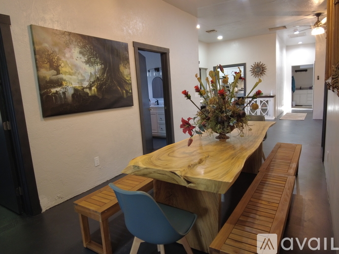 A dining area with a wooden table and chairs.