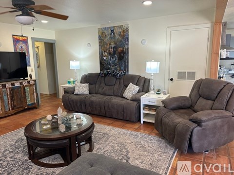A living room with a grey couch and a coffee table.