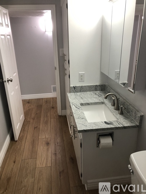 A bathroom with a sink and toilet paper roll.