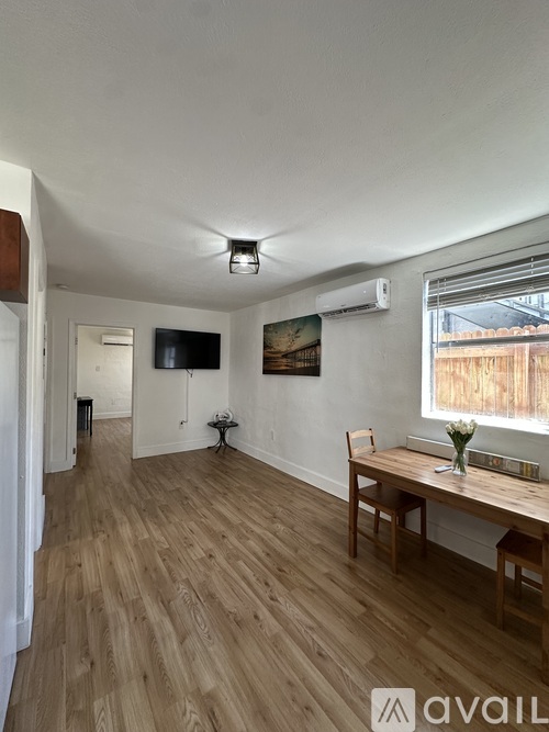 A room with wooden flooring and a ceiling fan.