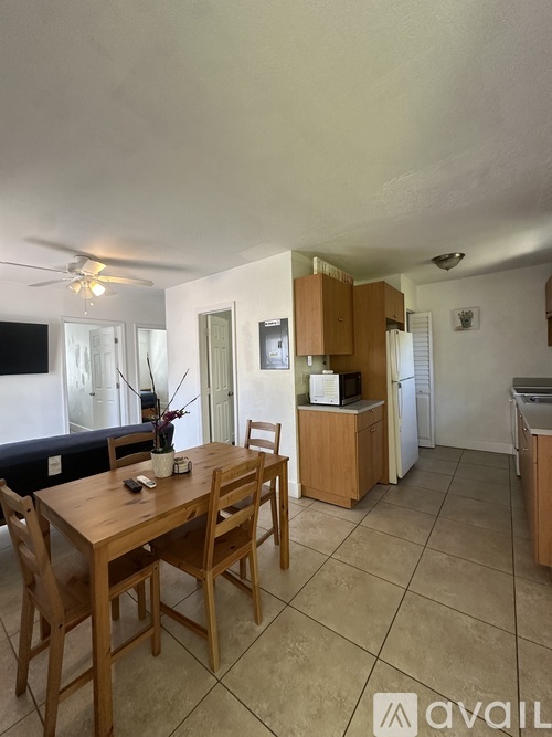 A kitchen with a table and chairs in the middle of the room.