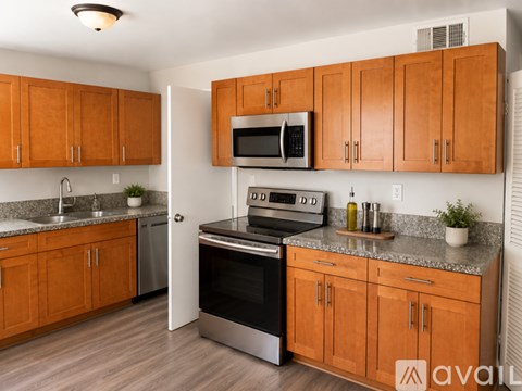 A kitchen with wooden cabinets and a black oven.