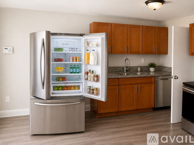 A stainless steel refrigerator with its door open, displaying a variety of food items.