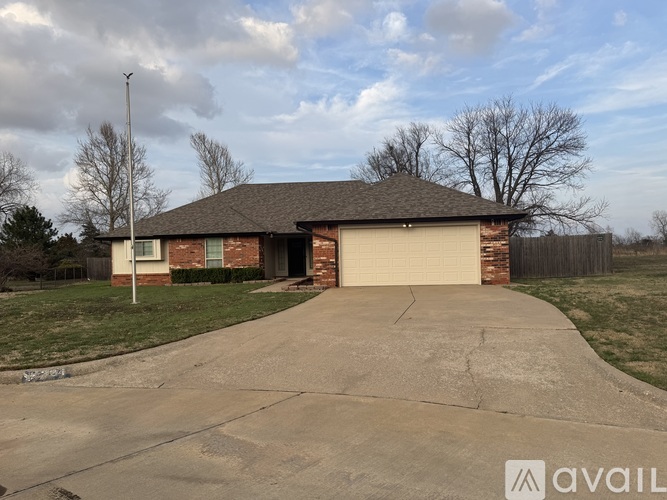 A house with a garage and a driveway in front.