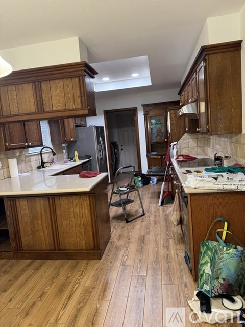A kitchen with wooden cabinets and a white countertop.