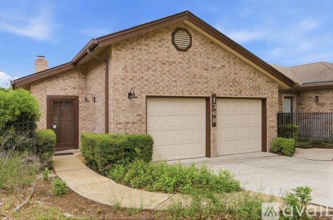 A house with a brown brick exterior and a brown door.