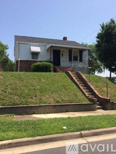 A house with a staircase leading to the front door.