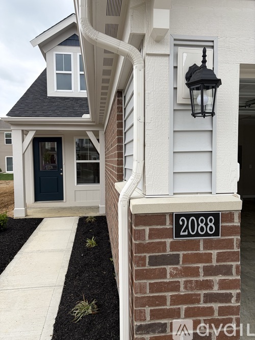 A house with a blue door and a black lantern on the wall.
