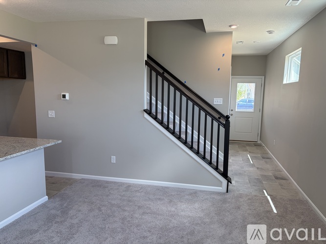 A spacious room with a staircase leading to the next level.