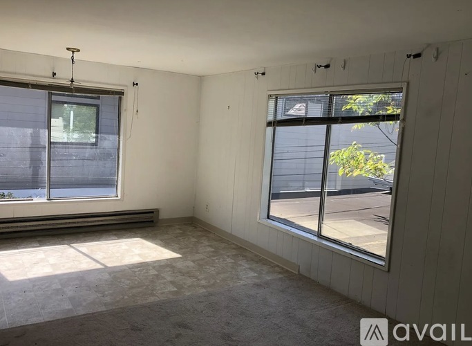 A room with a large window and a smaller window on the wall.