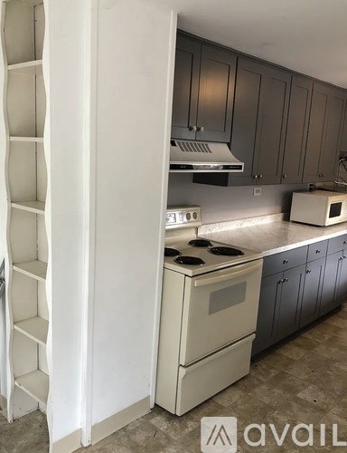 A white refrigerator with a stove and oven in a kitchen.