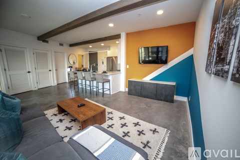 A modern living room with a grey sofa and a wooden coffee table.