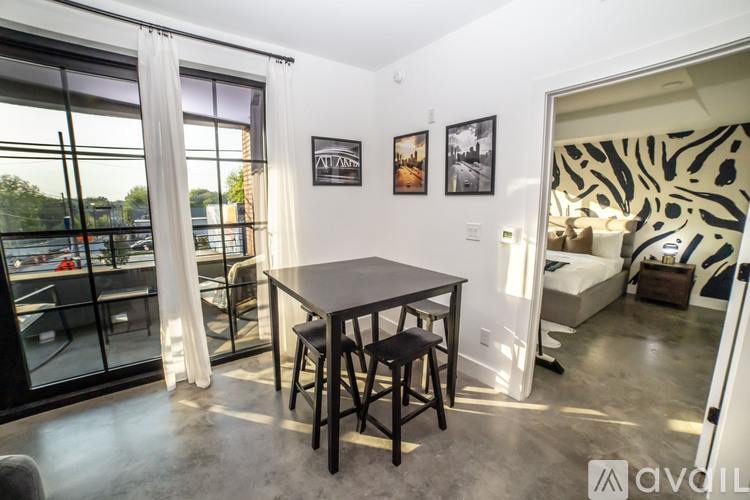 A modern dining area with a table and chairs is available for rent.