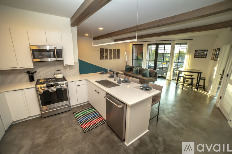 A modern kitchen with stainless steel appliances and white cabinets.