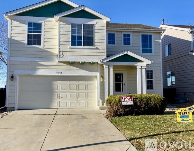 A two-story house with a garage is for rent.