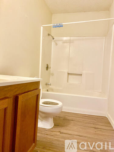 A bathroom with a toilet and a shower.