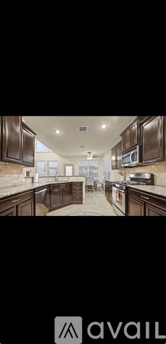 A modern kitchen with dark wood cabinets and a white countertop.