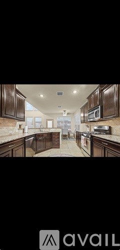 A modern kitchen with dark wood cabinets and a white countertop.