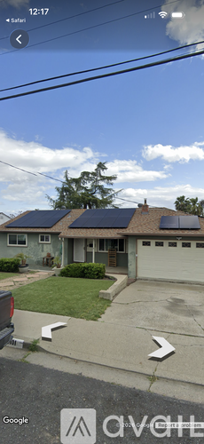A house with solar panels on the roof is visible.