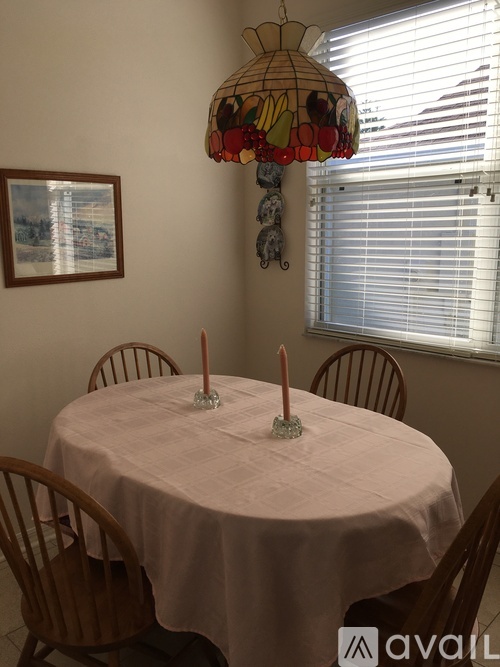 A dining room with a table set for two.