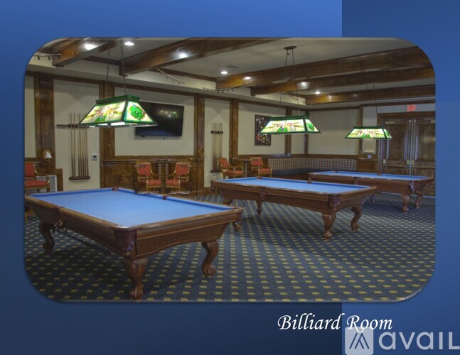 A billiard room with two tables and a pool table.