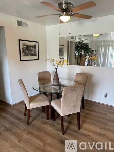 A dining room with a glass table and chairs.