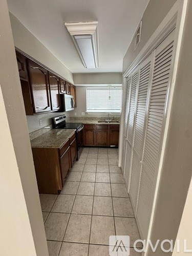 A kitchen with brown cabinets and a countertop.