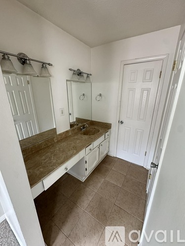 A bathroom with a vanity and a walk-in shower.